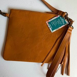 Simple leather crossbody bag. Strap is removable, has wristlet strap as well.